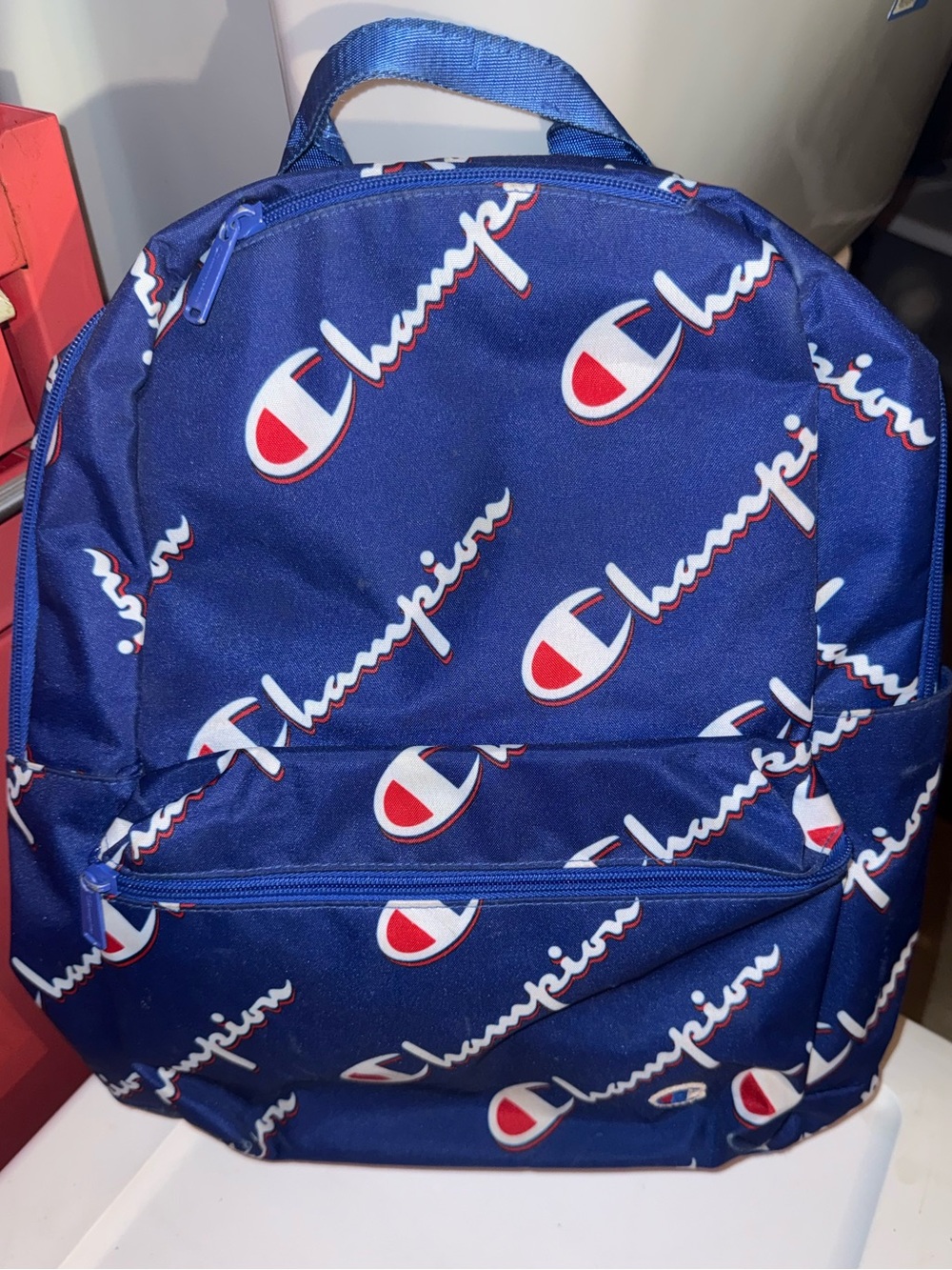 Champion Navy Blue All-Over Logo Backpack with Red & White Accents